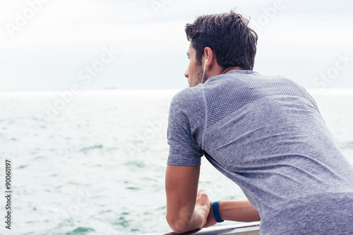Sports man looking at sea outdoors