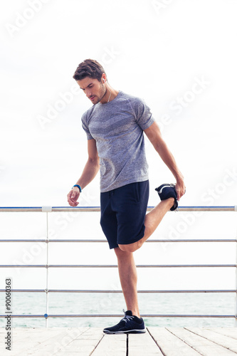 Man stretching legs outdoors