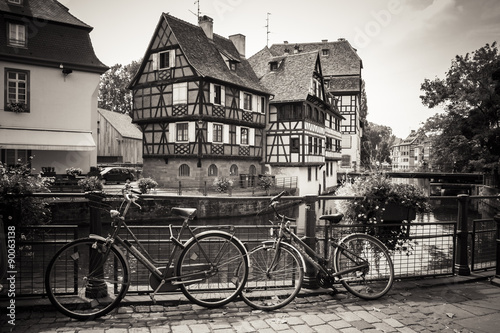 Bicycles in front of the River and Houses in Strasbourg, sepia edit #90063138