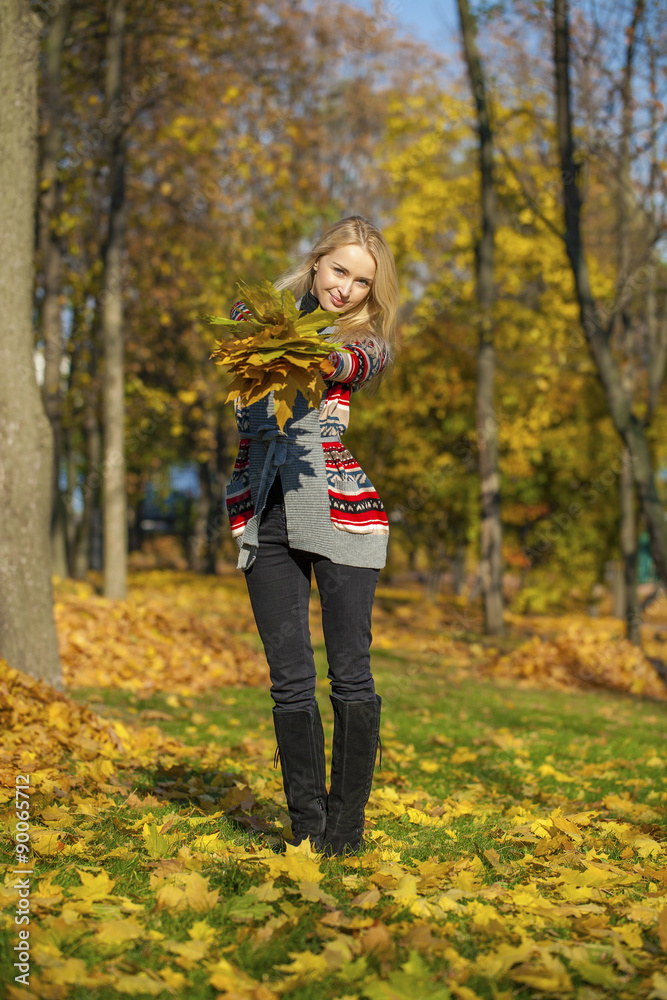 Happy Beautiful blonde woman walks in autumn park Happy Beautiful blonde woman walks in autumn park