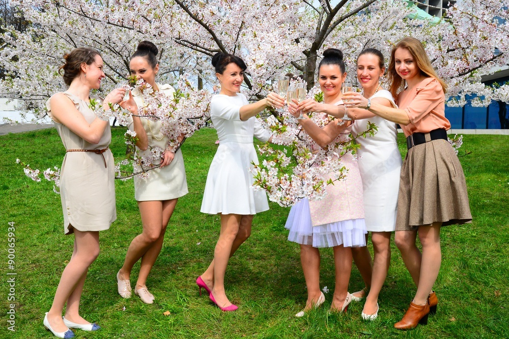 Girls with champagne celebrating in sakura's garden. Girls with champagne celebrating in sakura's garden.
