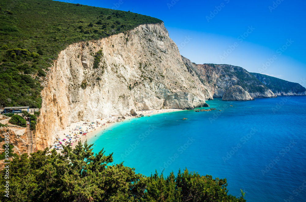 Porto Katsiki beach in Lefkada island, Greece. Beautiful view over the beach. The water is turquoise and there are a boat on the sea.