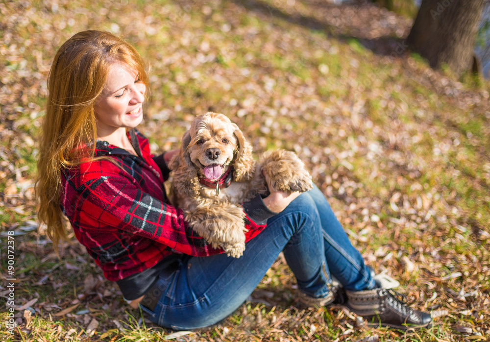 Pretty woman with beautiful cocker spaniel in autumn park Pretty woman with beautiful cocker spaniel in autumn park