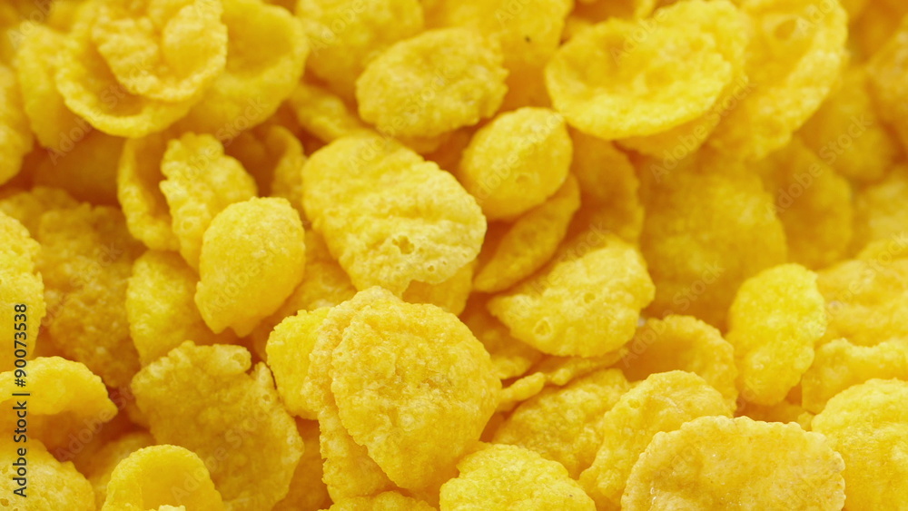 Corn flakes being poured into bowl. Corn flakes being poured into bowl.