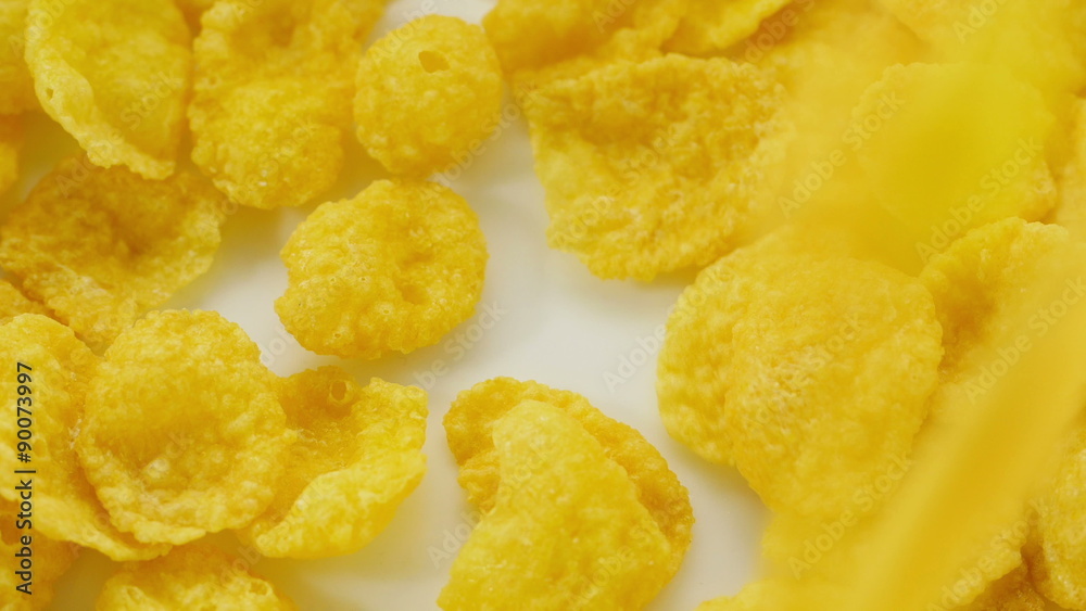 Corn flakes being poured into bowl. Close up.
Corn flakes being poured into bowl. Close up.