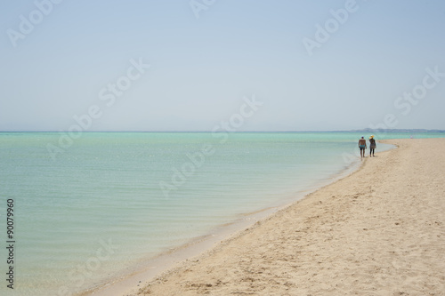 Couple walking on a tropical beach