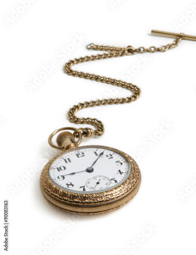 Vintage gold watch with chain lying on white background