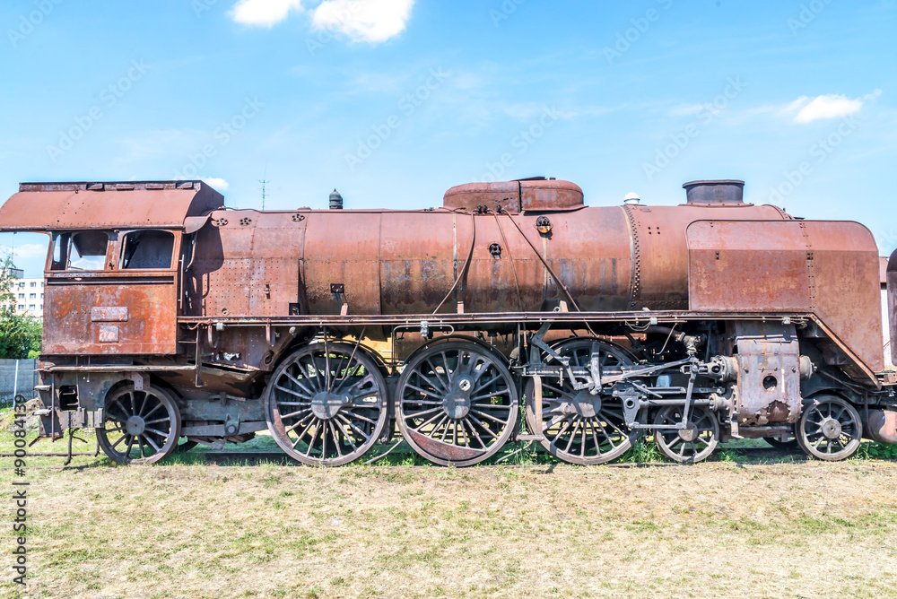 Old Czechoslovakian CSD steam engine on graveyard, rusty