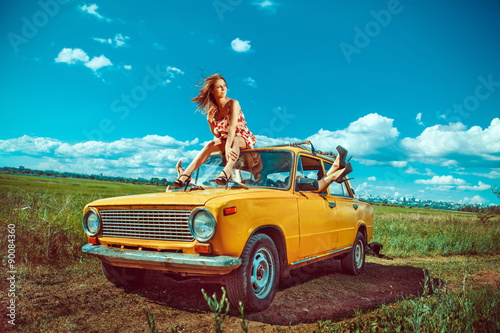 Group of beautiful women in the old yellow car