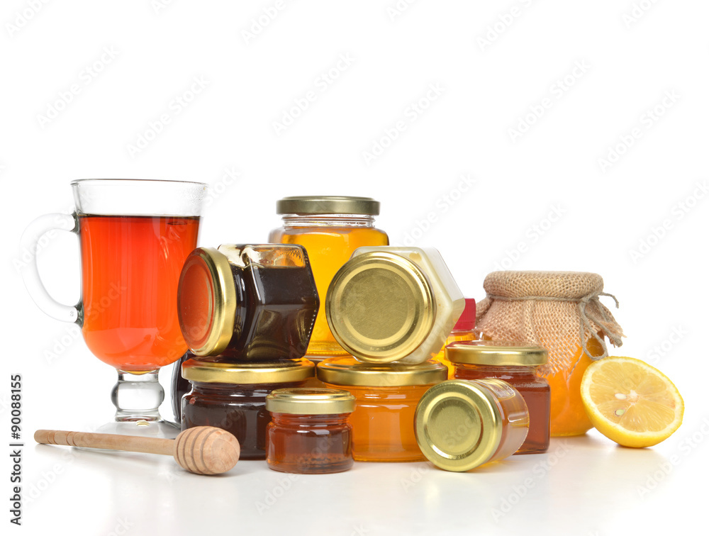 Tasty jars of jam and honey cream lemon and tea Tasty jars of jam and honey cream lemon and tea