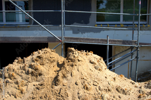 Common on building lots a sandheap next to a shell construction, constrution industry, real estate photo