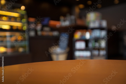 Empty round table top at coffee shop blurred background with bok