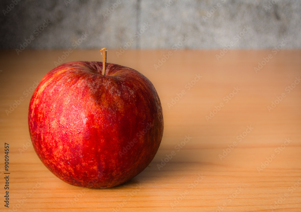 Red Apple on a wooden table with Dramatic lighting, Selective focus. Red Apple on a wooden table with Dramatic lighting, Selective focus.