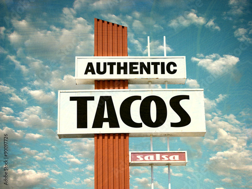 aged and worn vintage photo of tacos and salsa sign