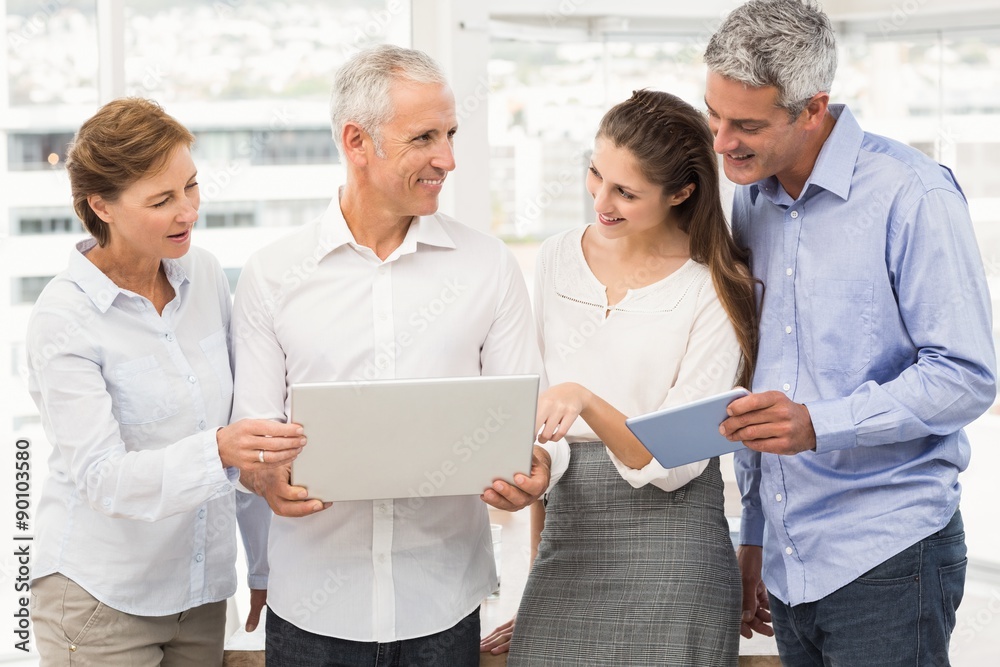 Smiling business people using laptop Smiling business people using laptop