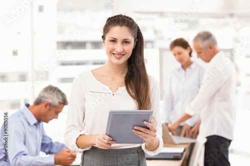 Smiling businesswoman with tablet in a meeting 