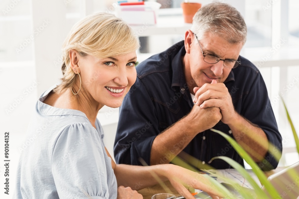 Fototapeta premium Smiling business team working on laptop