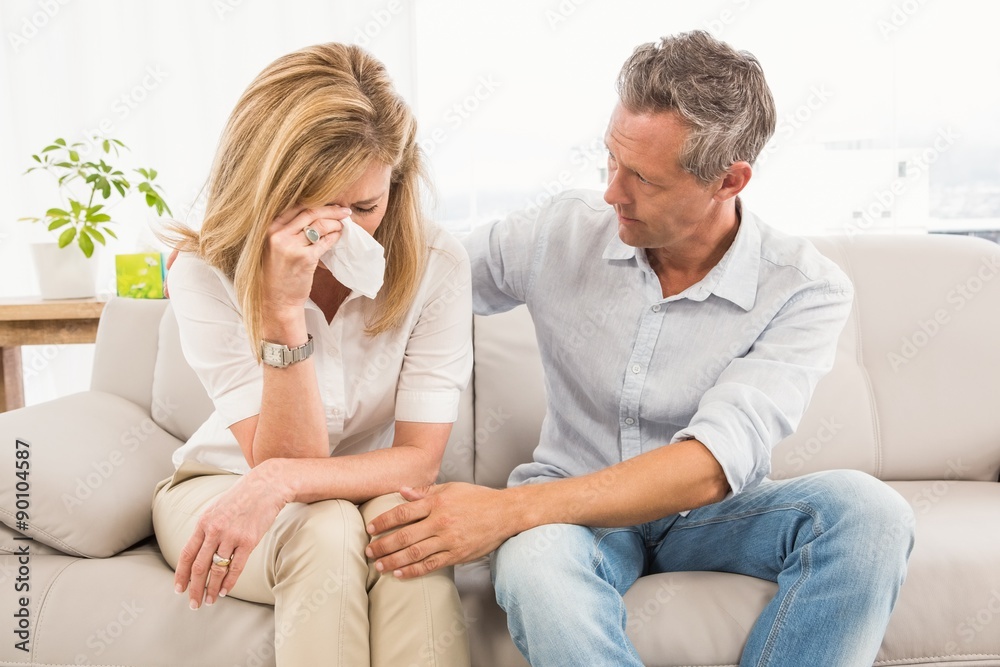 Concerned therapist comforting crying female patient Concerned therapist comforting crying female patient