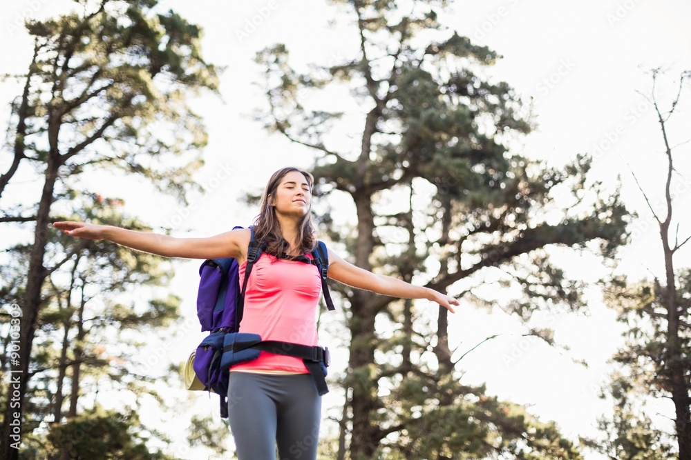 Young happy jogger standing on rock feeling free Young happy jogger standing on rock feeling free