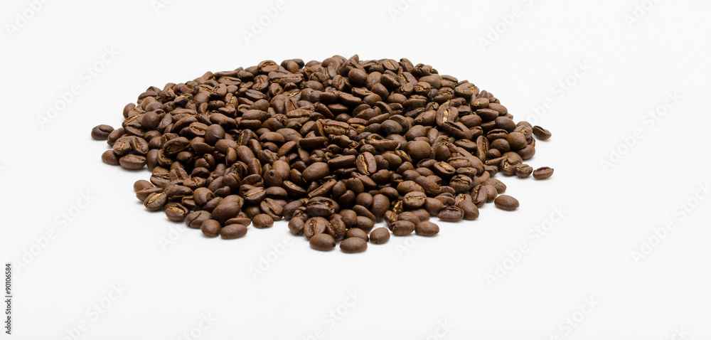 Roasted coffee beans pile from top on white background Roasted coffee beans pile from top on white background