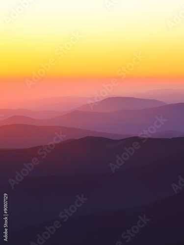 mountain peaks at sunset haze