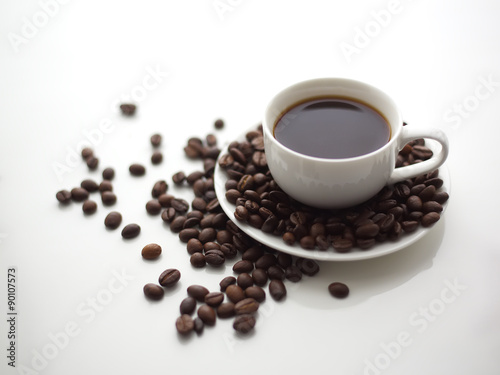 Cup of coffee and coffee beans on a white