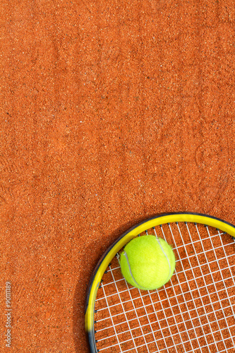 Sport background with a tennis racket and ball. Vertical image. © g215