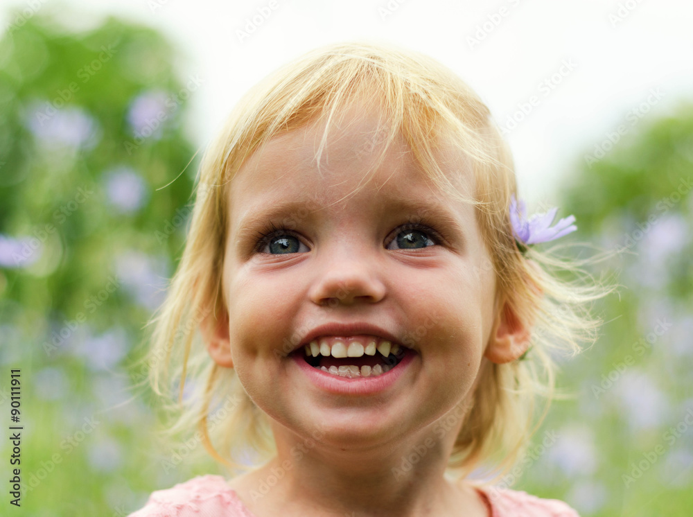 Cute little girl in a pink dress smiling in park Cute little girl in a pink dress smiling in park