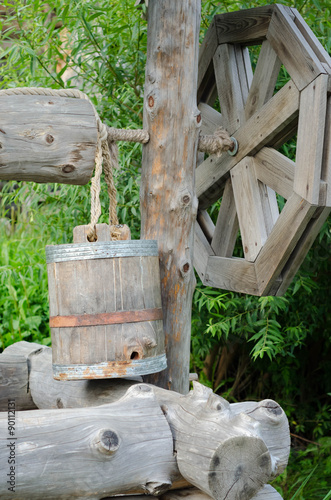 Old draw well with wooden bucket