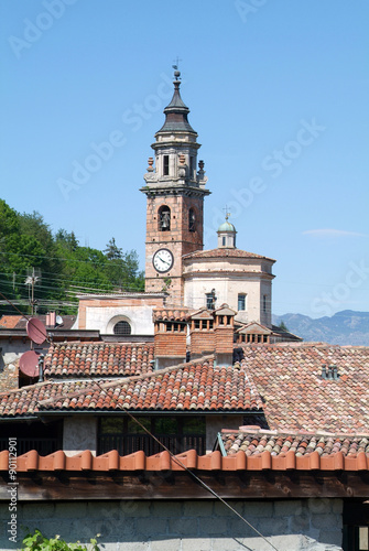 Red tiled roofs and an ancient church in Carona