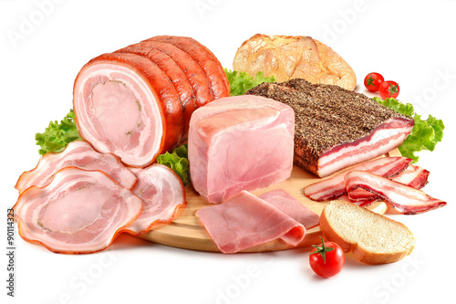 Cutting board with pork, bacon, ham and bread photo