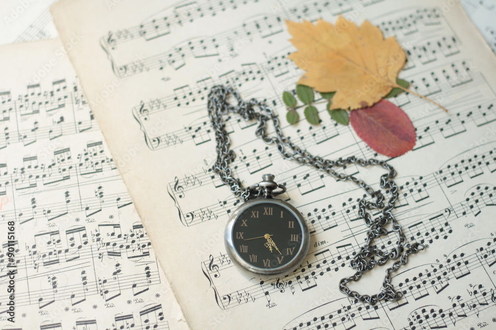 Old watch and dead tree leaves laying on old piano musical notes Stock  Photo | Adobe Stock
