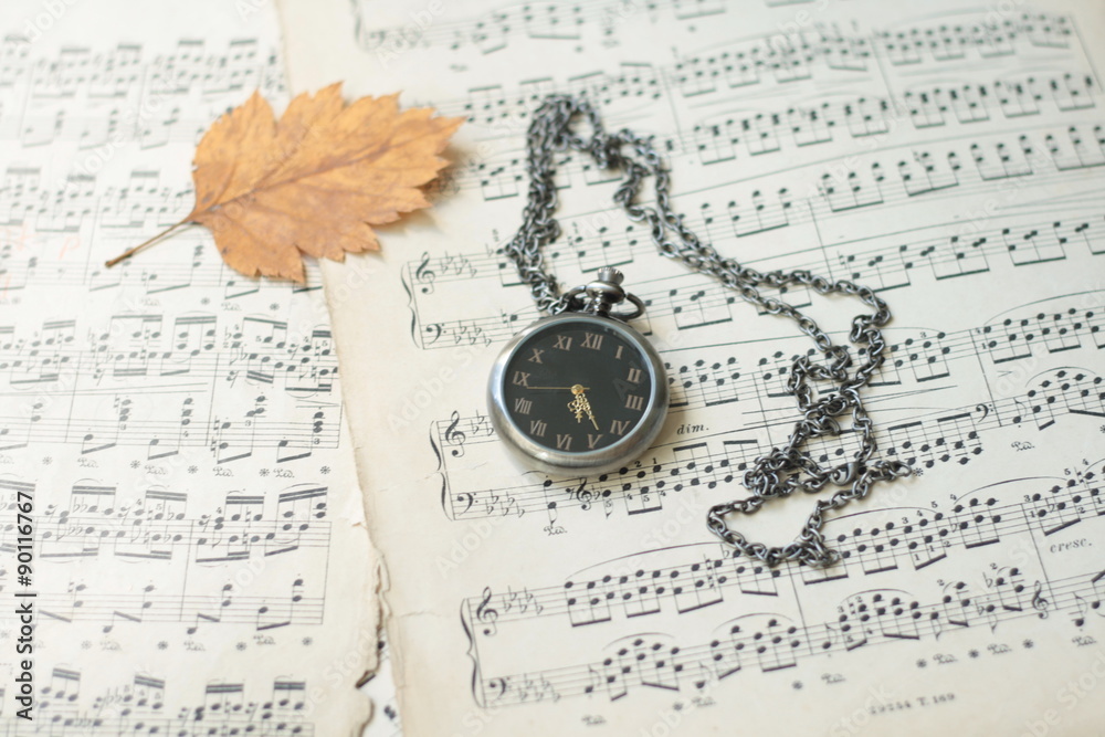 Old watch and dead tree leaves laying on old piano musical notes Stock  Photo | Adobe Stock