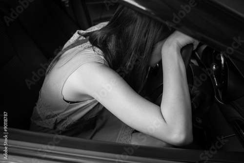 BW tone of Drunk woman asleep at the wheel