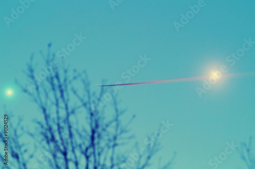 Fototapeta Naklejka Na Ścianę i Meble -  Venus and Jupiter in the sky with a tree silhouette and airplane trail. Taken through my telescope.