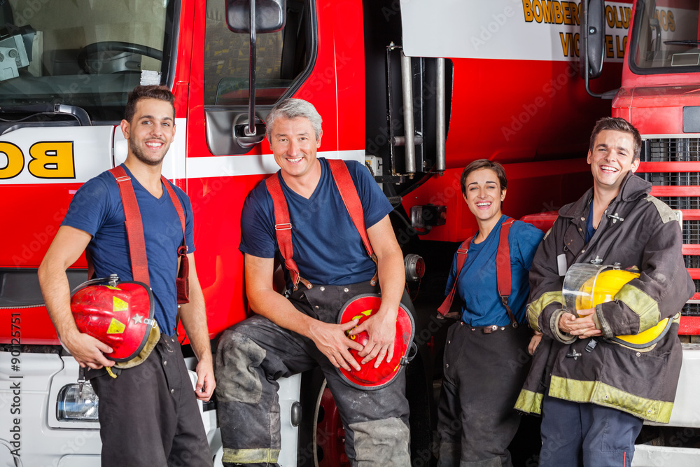 Fototapeta premium Team Of Happy Firefighters At Fire Station