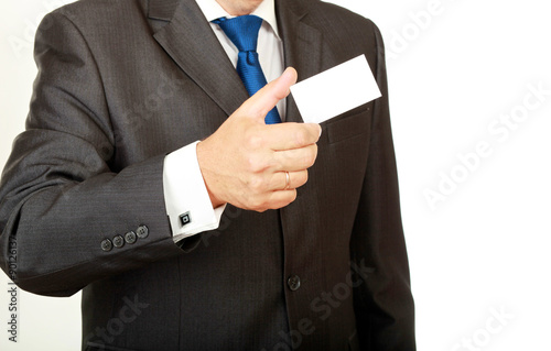 Man's hand showing business card - closeup shot on grey