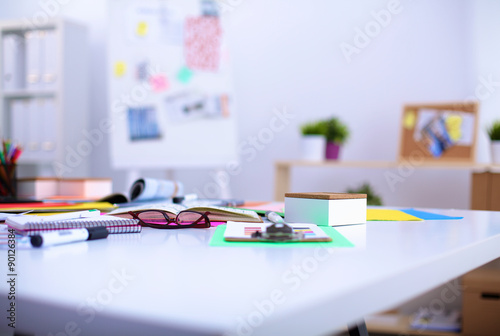 Desk of an artist with lots of stationery objects. Studio shot