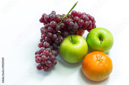 Apple, grapes and oranges on white background