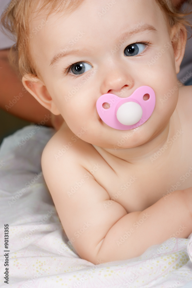 Adorable baby face with a pacifier in his mouth close up Adorable baby face with a pacifier in his mouth close up