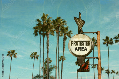 aged and worn vintage photo of protester area sign