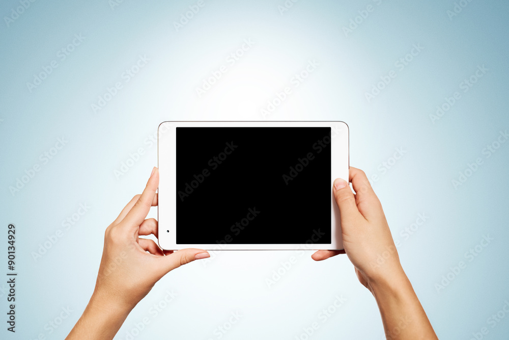 Woman hands holding contemporary generic tablet pc with blank sc Woman hands holding contemporary generic tablet pc with blank sc