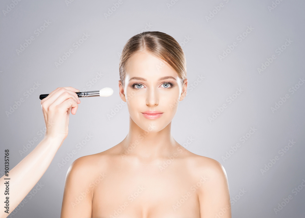 Beautiful girl is being applied with cosmetics. Beautiful girl is being applied with cosmetics.