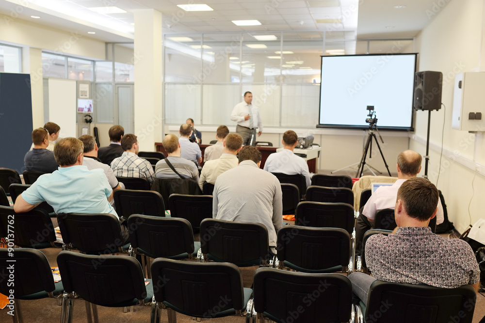 The audience listens to the acting in a conference hall