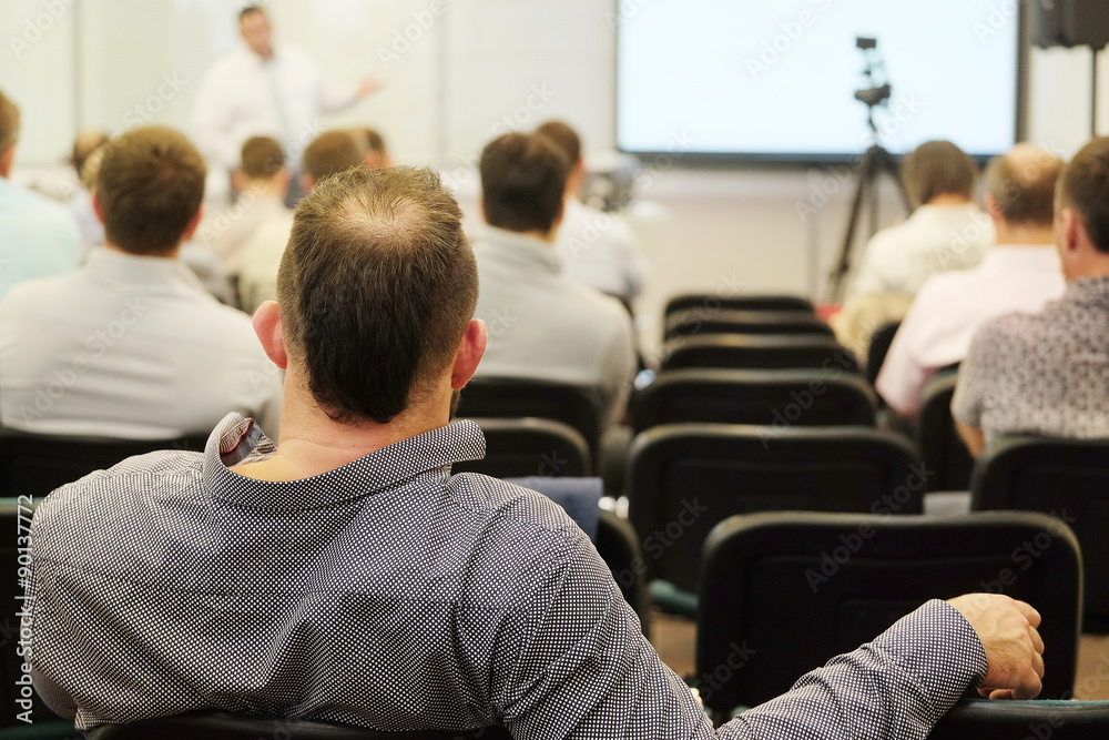 The audience listens to the acting in a conference hall