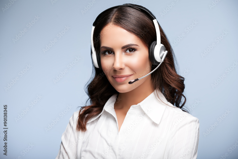 Portrait of smiling customer support female phone worker, agains Portrait of smiling customer support female phone worker, agains