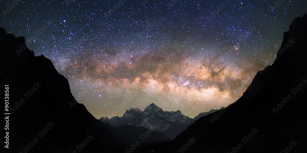 Bowl of Heavens. Bright and vivid Milky Way galaxy over the snowy mountains. Beautiful starry night sky seems to be in a "bowl" between the silhouetted hills. - obrazy, fototapety, plakaty 