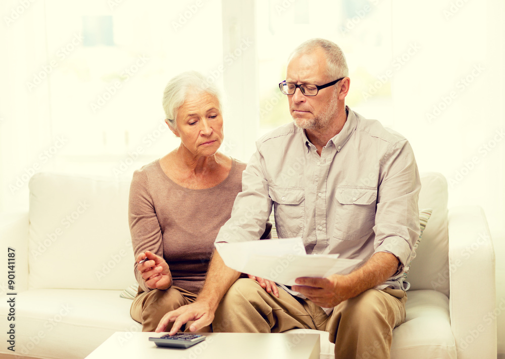 Fototapeta premium senior couple with papers and calculator at home
