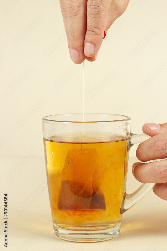 Hands brewed strong fresh tea in a glass Hands brewed strong fresh tea in a glass