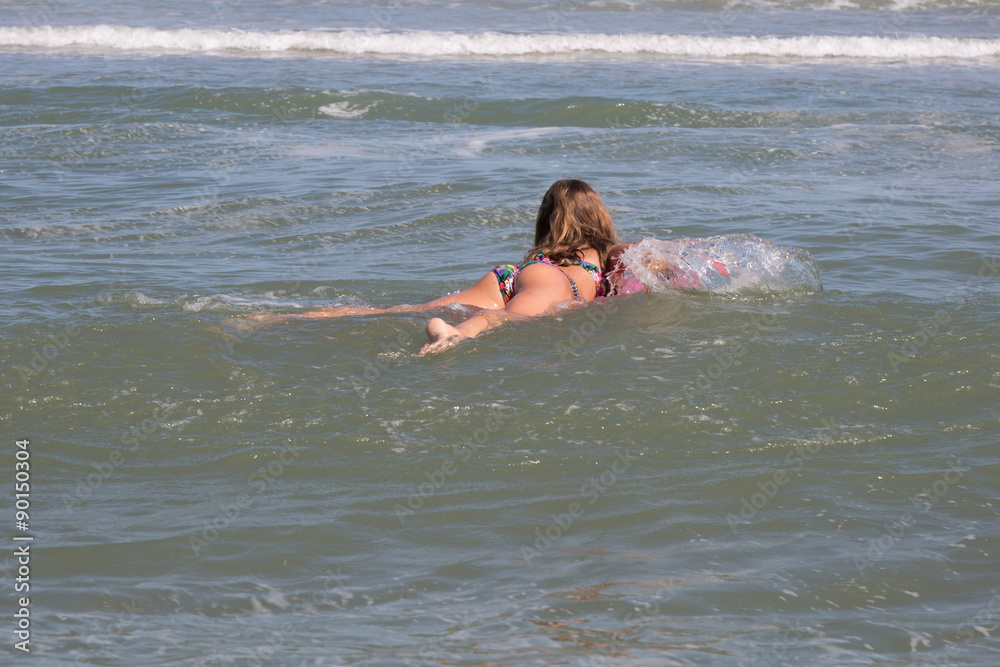 Lovely girl at the beach with her bodyboard